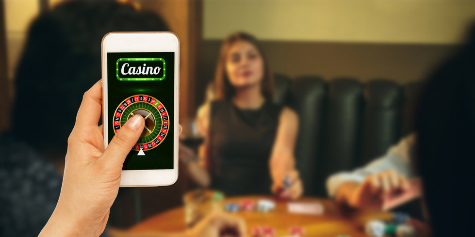 Online gambling, casino concept Hand holding device with lottery, casino cover